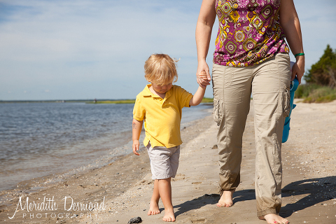Mom and Son walking on the beach hand in hand